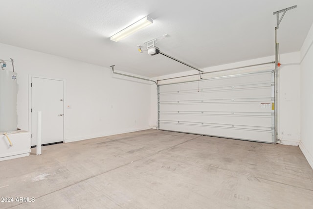 garage featuring electric water heater and a garage door opener