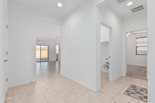 corridor featuring light tile patterned floors