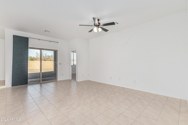 tiled empty room featuring ceiling fan