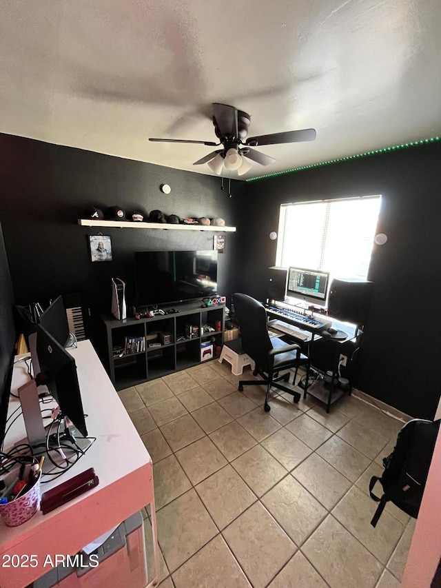 office area with light tile patterned floors and ceiling fan