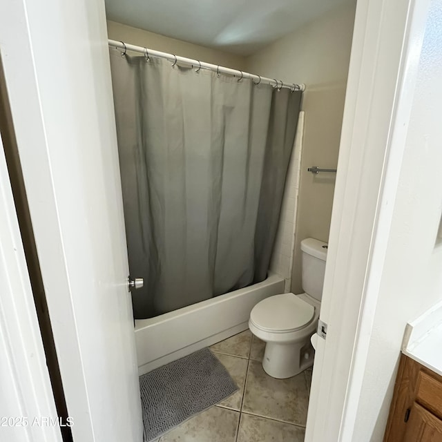 full bathroom featuring toilet, tile patterned floors, and shower / tub combo