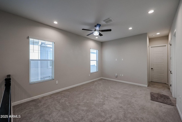 unfurnished room featuring light colored carpet and ceiling fan