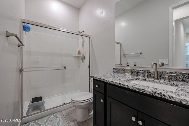 bathroom with vanity, an enclosed shower, tile patterned flooring, and toilet