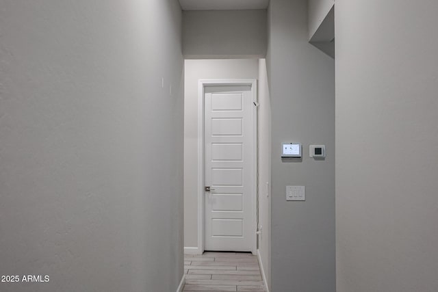 corridor with light hardwood / wood-style flooring