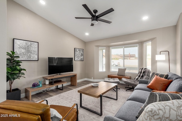 living room featuring ceiling fan, lofted ceiling, and light wood-type flooring