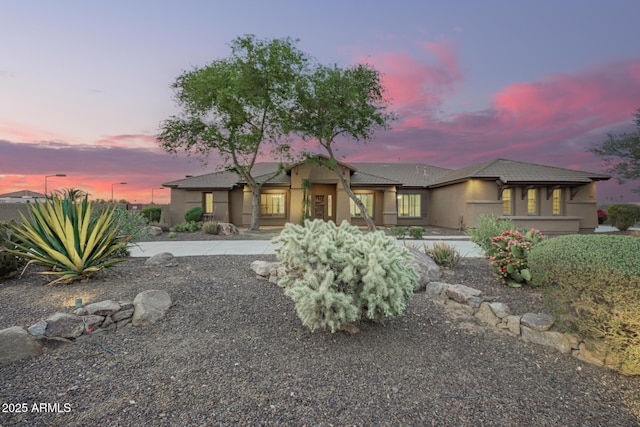 view of front of property featuring stucco siding and a tile roof