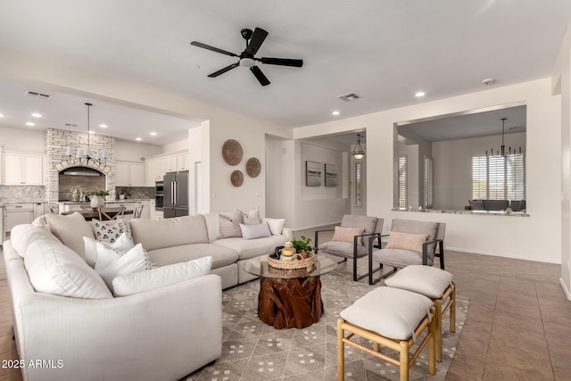 living area featuring tile patterned floors, a ceiling fan, visible vents, and recessed lighting