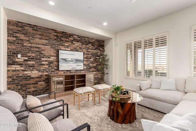 living room featuring brick wall and recessed lighting