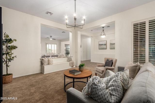carpeted living area with a notable chandelier, visible vents, and baseboards