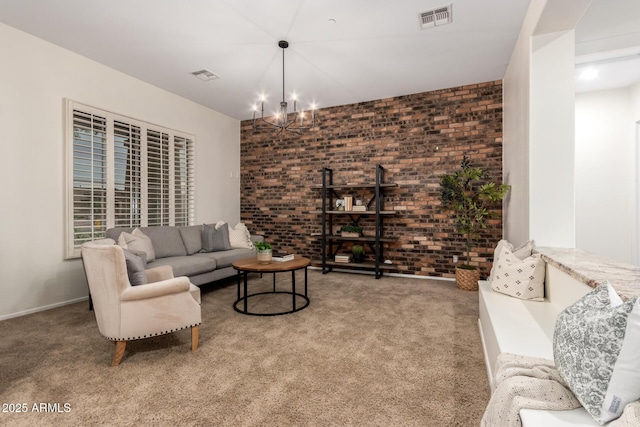 living area with brick wall, visible vents, an inviting chandelier, and carpet floors
