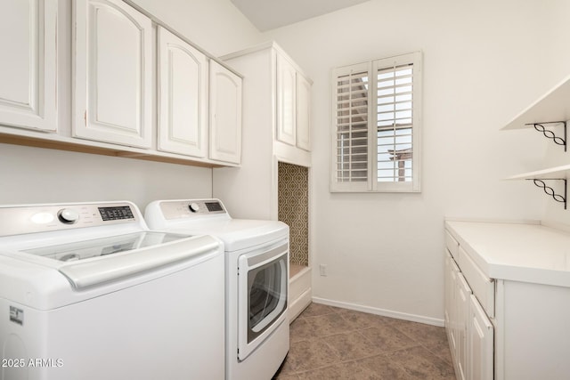 laundry room featuring cabinet space, baseboards, separate washer and dryer, and light tile patterned flooring