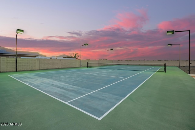 view of tennis court featuring community basketball court and fence