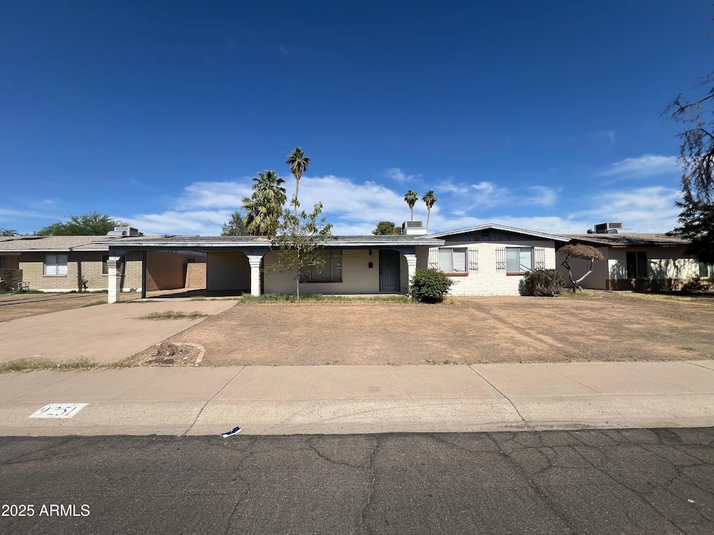 9251 N 36th Dr, Phoenix, AZ 85051 - ranch-style house with driveway and a carport
