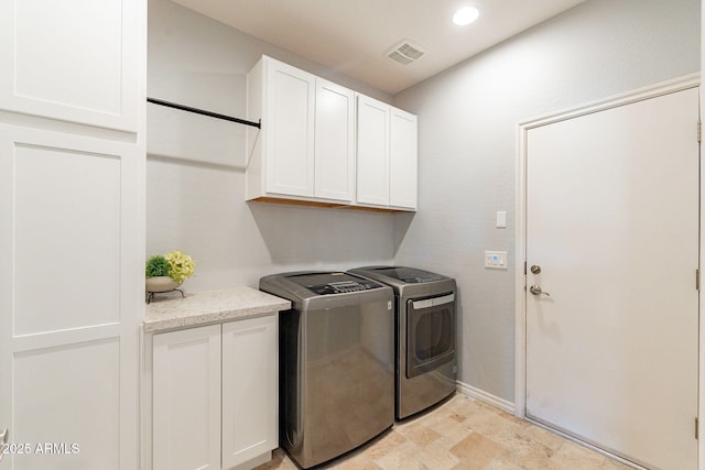 laundry area featuring cabinets and washing machine and dryer