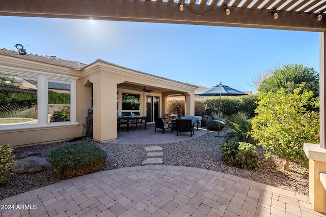 view of patio featuring ceiling fan and a pergola