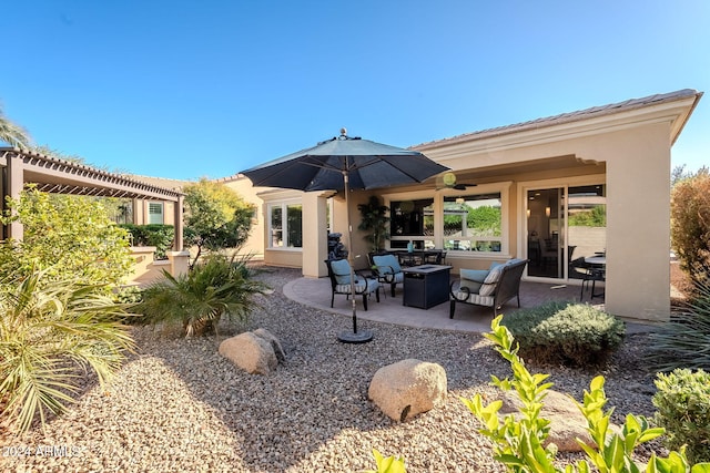 back of property featuring ceiling fan and a patio area