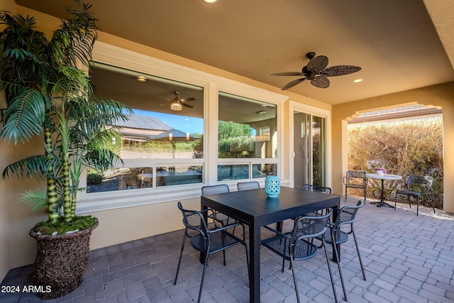 sunroom / solarium featuring ceiling fan