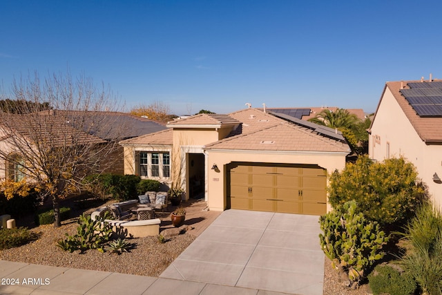 view of front of property with a garage and solar panels