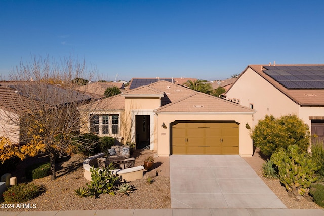 view of front facade with a garage and solar panels