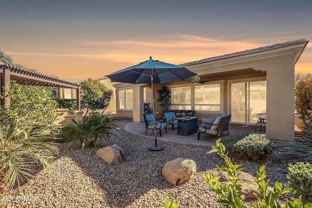 back house at dusk featuring a patio area