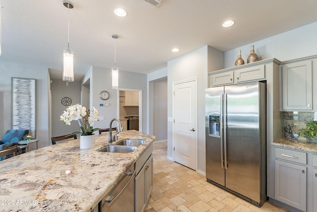 kitchen featuring sink, gray cabinetry, hanging light fixtures, stainless steel appliances, and decorative backsplash