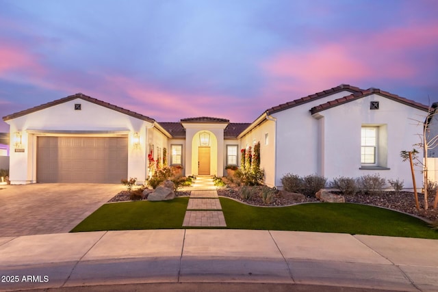 mediterranean / spanish-style house with a garage