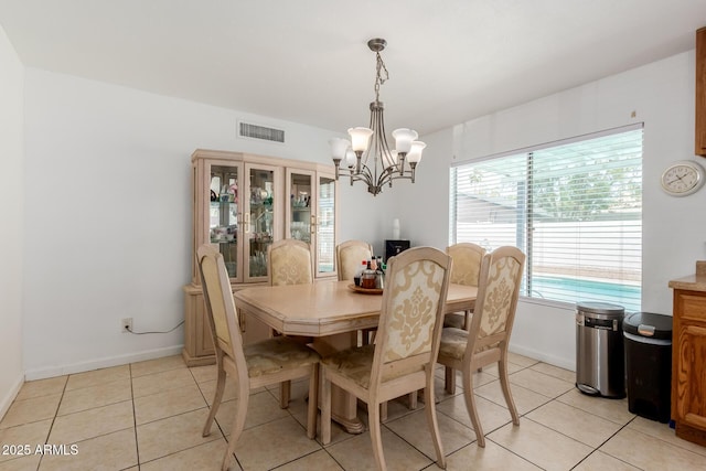 dining area with visible vents, baseboards, light tile patterned floors, and a notable chandelier