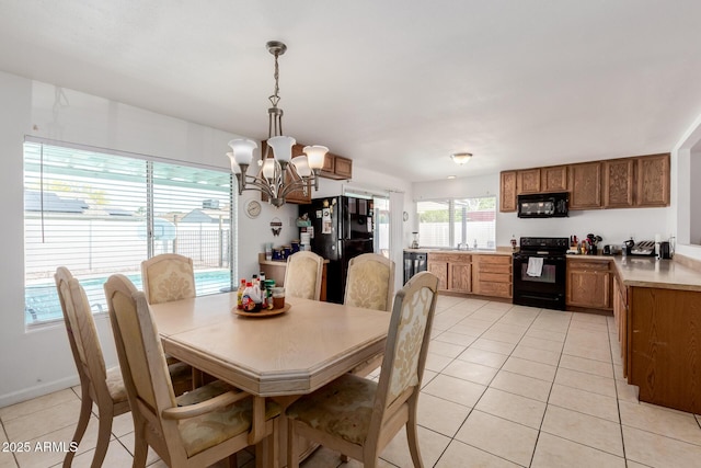 dining room featuring a notable chandelier and light tile patterned floors