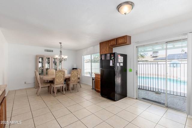 dining area with visible vents, baseboards, light tile patterned flooring, and a notable chandelier