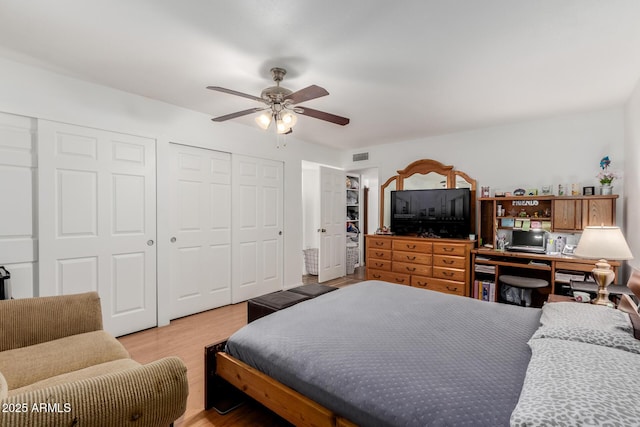 bedroom with a ceiling fan, light wood-style flooring, and visible vents