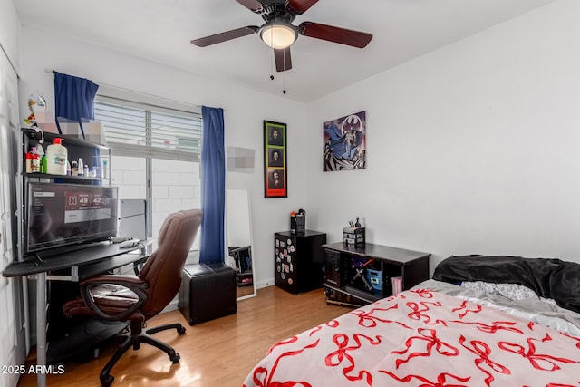 bedroom with a ceiling fan and wood finished floors