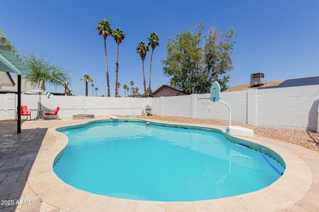 view of pool with a fenced in pool, a fenced backyard, a patio area, and cooling unit