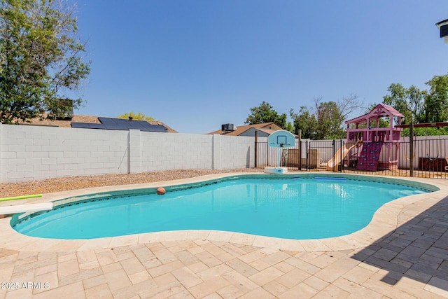 view of swimming pool featuring a fenced in pool, a fenced backyard, a playground, and a patio