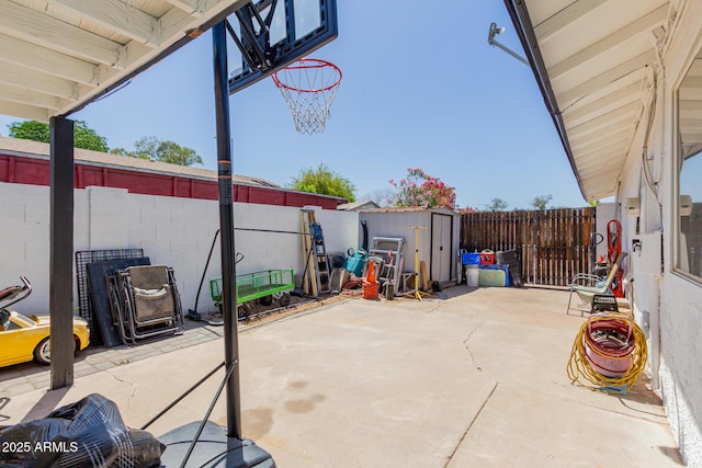 view of patio / terrace featuring a fenced backyard, a shed, and an outbuilding