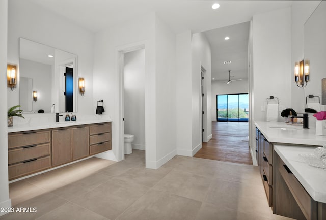 bathroom featuring toilet, vanity, ceiling fan, and tile flooring