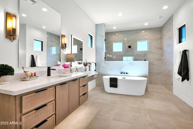 bathroom featuring tile walls, separate shower and tub, tile floors, and vanity with extensive cabinet space