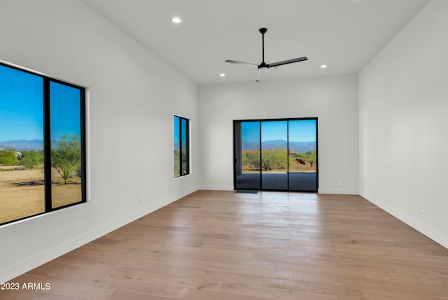 spare room featuring light hardwood / wood-style floors and ceiling fan