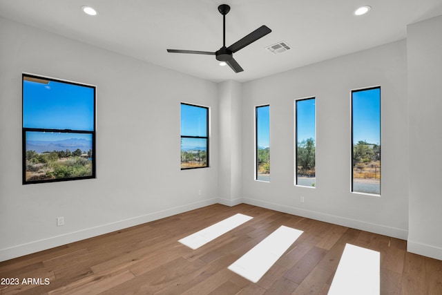 empty room with light hardwood / wood-style flooring and ceiling fan