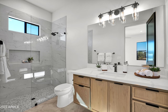 bathroom featuring tile flooring, toilet, vanity, and an enclosed shower