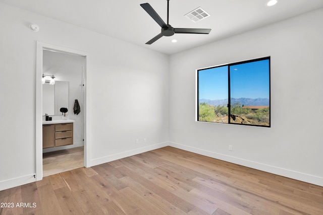 unfurnished bedroom featuring light tile floors, ceiling fan, and ensuite bathroom