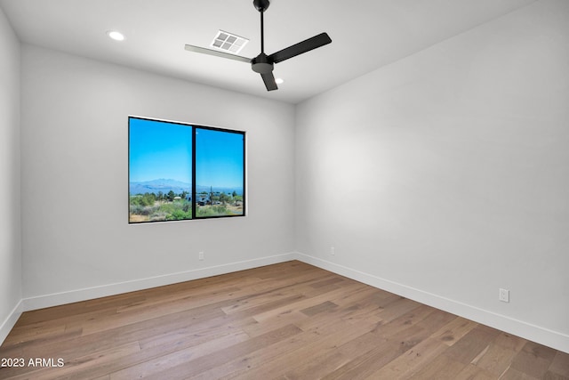 spare room with ceiling fan and light wood-type flooring