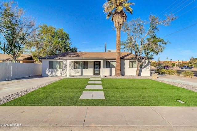 single story home featuring a front lawn