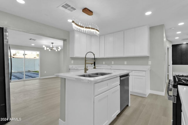 kitchen with light wood-type flooring, sink, decorative light fixtures, an inviting chandelier, and white cabinetry