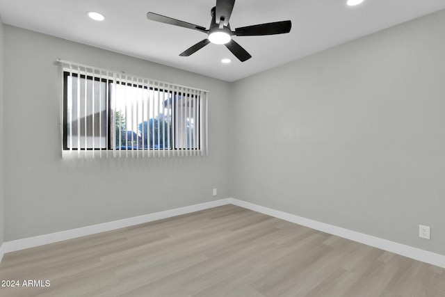 unfurnished room with ceiling fan and light wood-type flooring