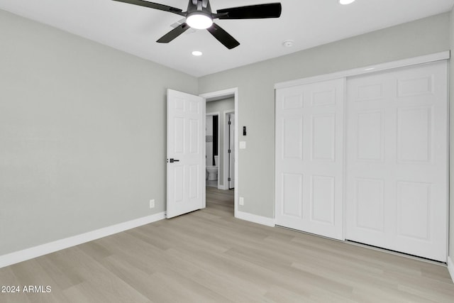 unfurnished bedroom with ceiling fan, a closet, and light hardwood / wood-style flooring