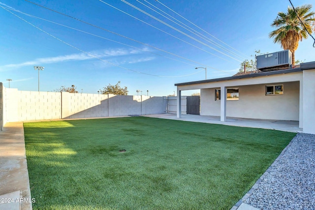 view of yard featuring central AC and a patio area