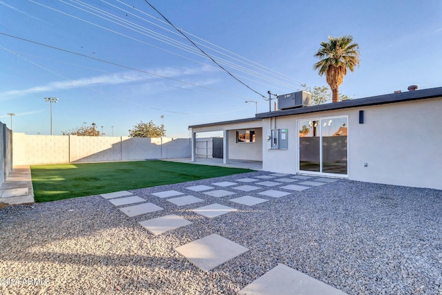 back of house with a yard, a patio, and central AC unit