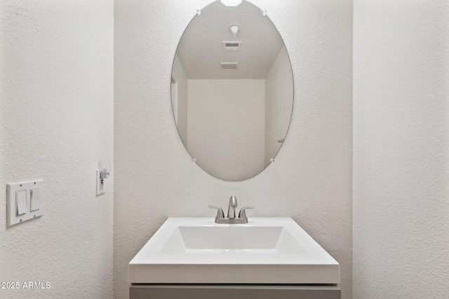 bathroom featuring visible vents and a sink