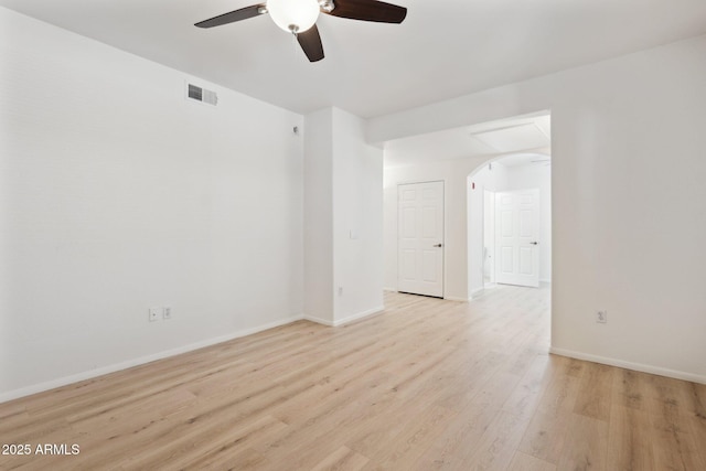 unfurnished room featuring visible vents, baseboards, light wood-type flooring, arched walkways, and a ceiling fan