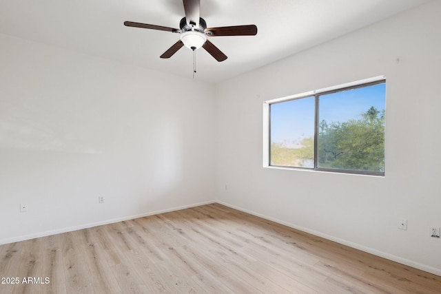 unfurnished room with baseboards, ceiling fan, and light wood-style floors